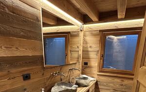 Guest bathroom with carved stone sinks and large shower