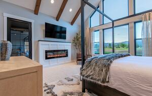 The "Grand" master suite, sitting area w/ 65" TV & fireplace