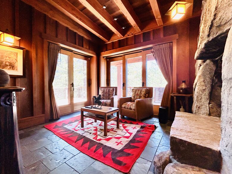 Native American art-filled den with fireplace, deck & views