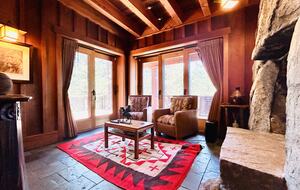 Native American art-filled den with fireplace, deck & views