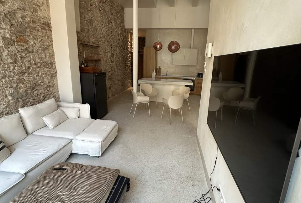 Open living space with 5m ceilings, and original walls