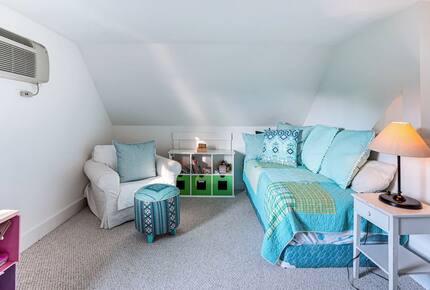 Loft area has two twin beds, a window, and built in A/C unit