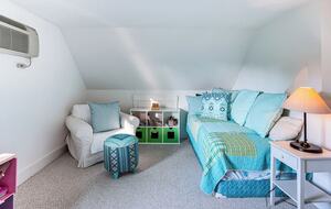 Loft area has two twin beds, a window, and built in A/C unit