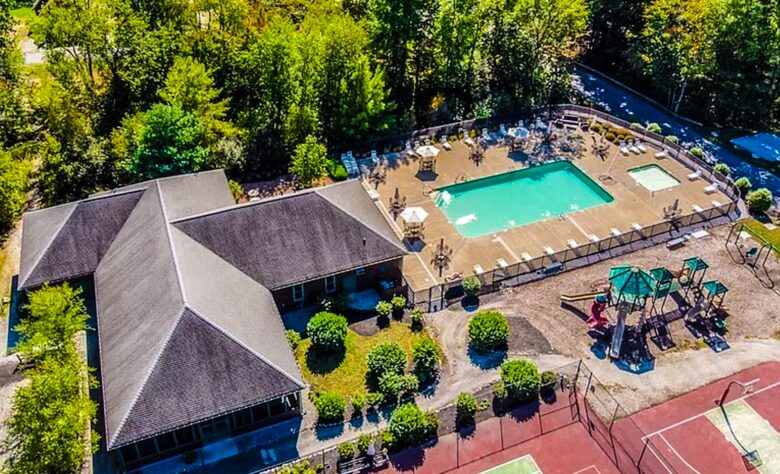 Aerial view of family pool, adjoins w/ bathrooms & pavilion
