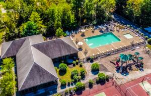 Aerial view of family pool, adjoins w/ bathrooms & pavilion