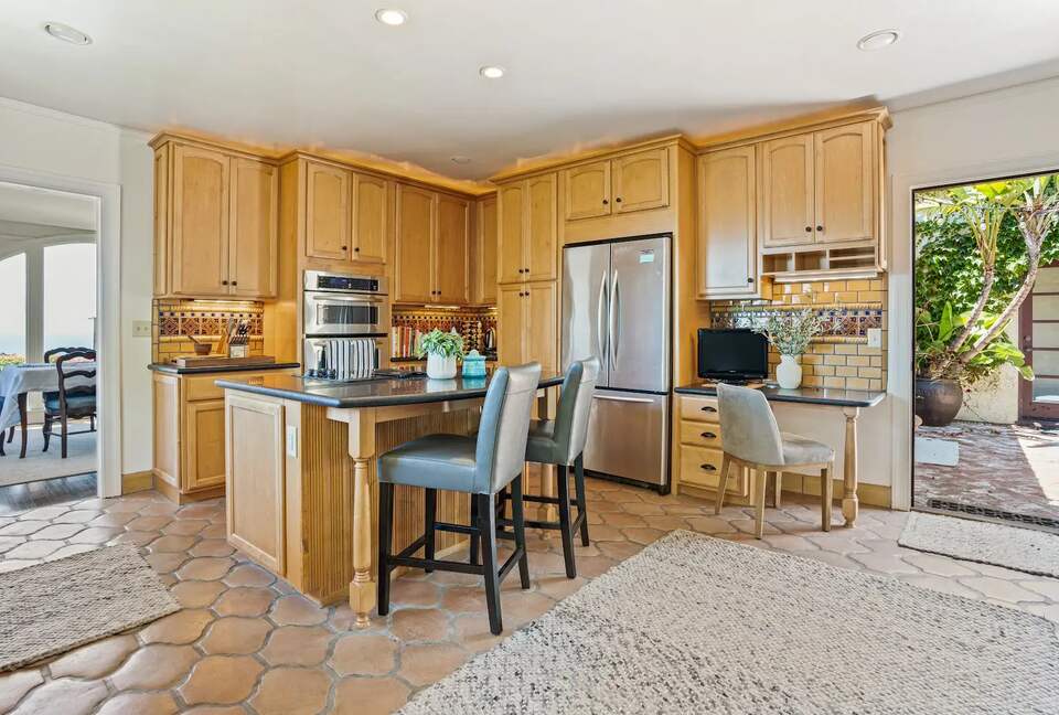 Kitchen opens to back patio and dining room