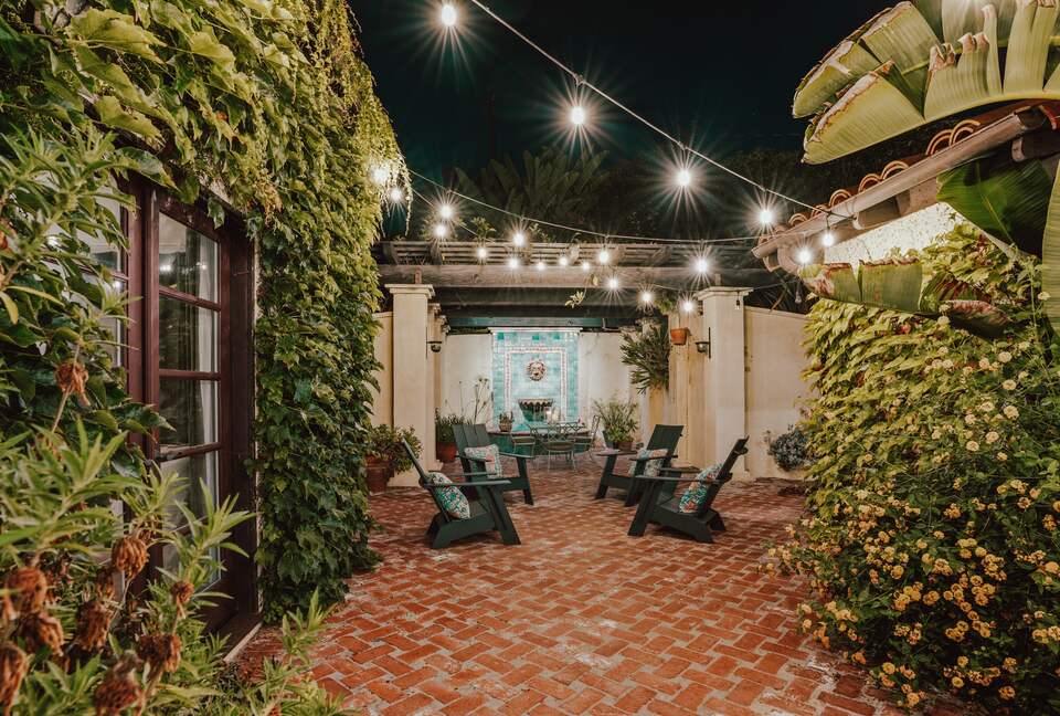 Back patio fountain, dining table, seating, string lights