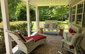 Welcoming front porch w/ ample seating & outdoor grill.