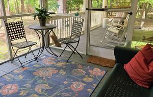 Screened porch looks out to lake.