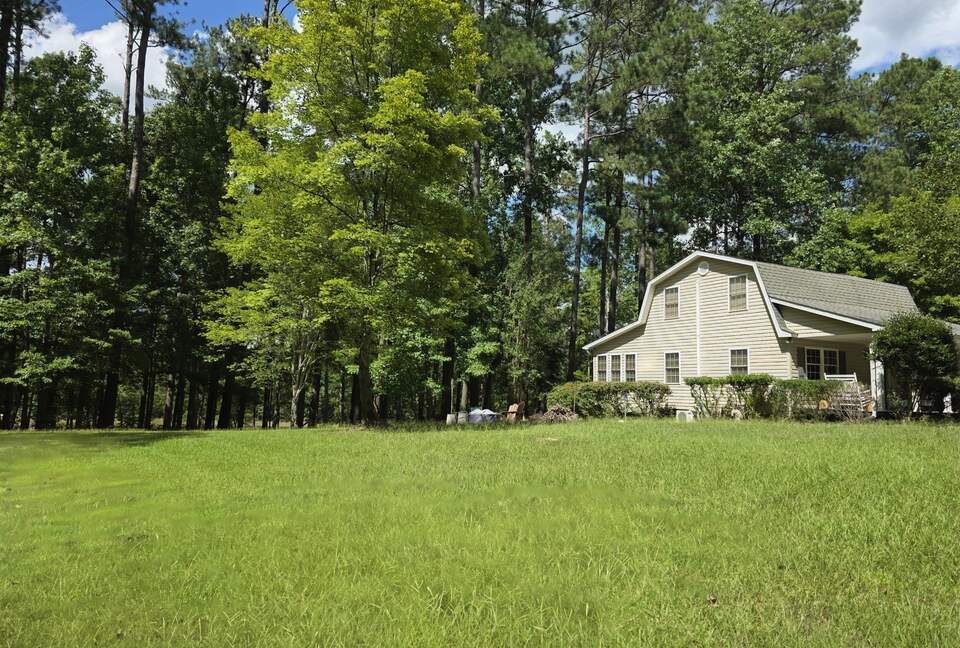 Large & open yard w/ nature path, firepit, seating & EV plug in.