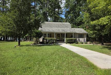 Front of home with lake.