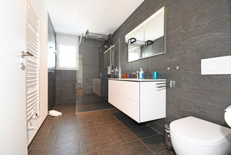 Large bathroom with a rain shower