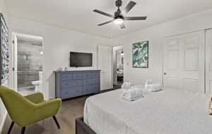 Master bedroom with dresser and smart TV