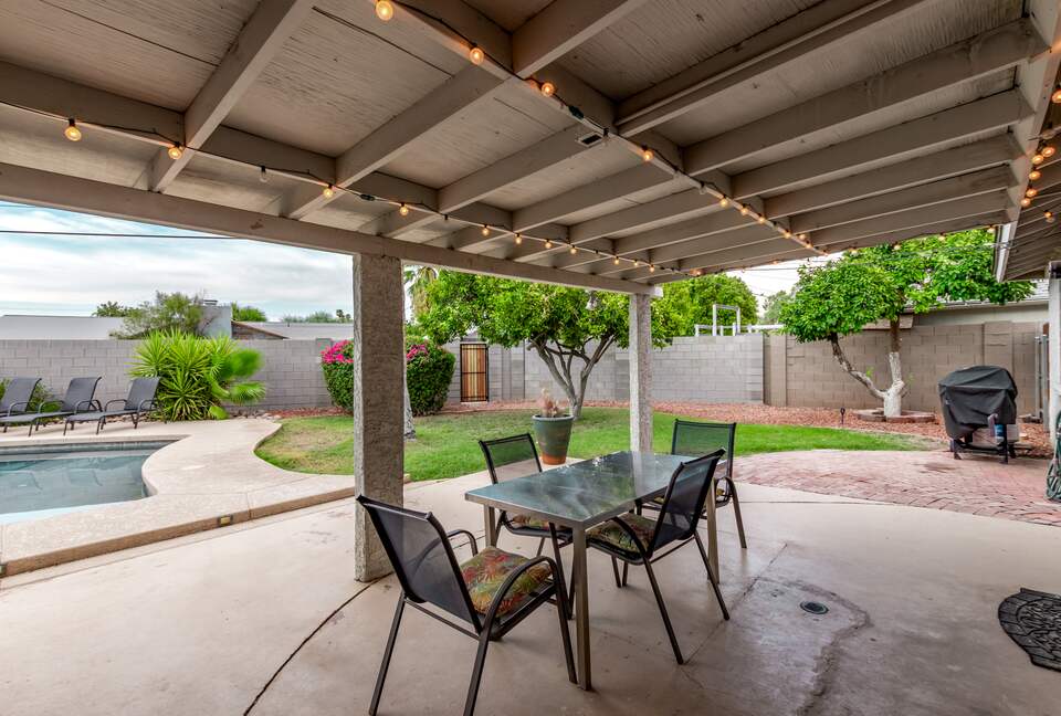 Covered patio with outdoor dining and BBQ
