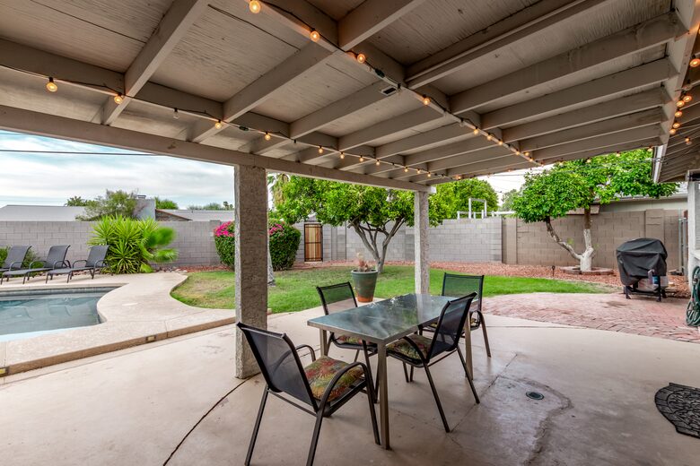 Covered patio with outdoor dining and BBQ