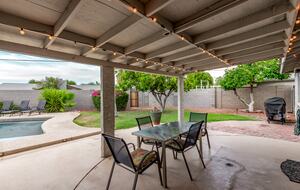 Covered patio with outdoor dining and BBQ