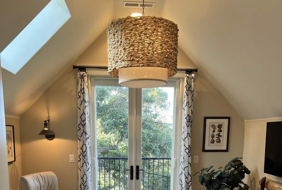 Primary sitting room with fireplace and balcony