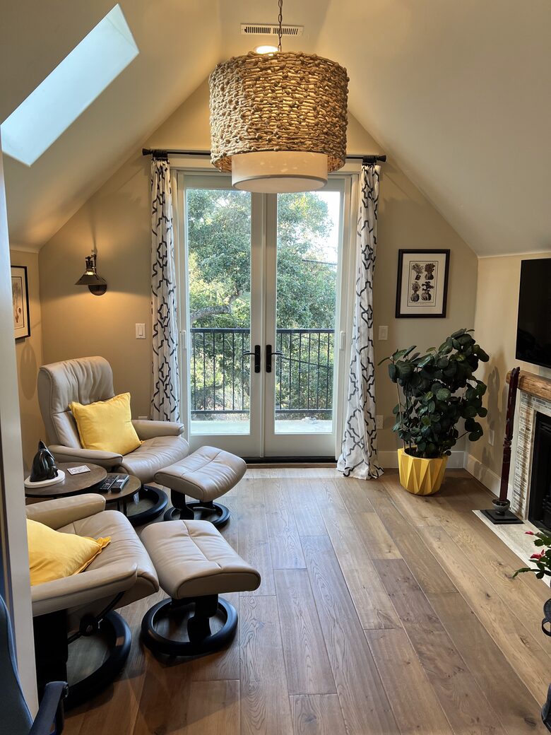 Primary sitting room with fireplace and balcony