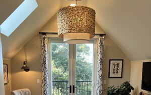 Primary sitting room with fireplace and balcony