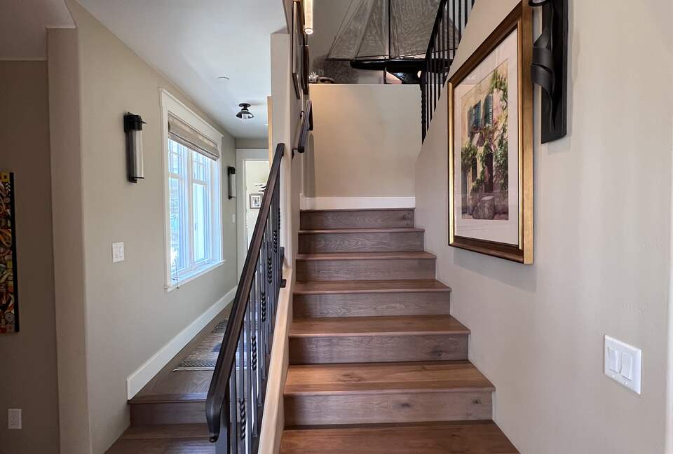 Upstairs to primary bedroom, bath, and room with balcony
