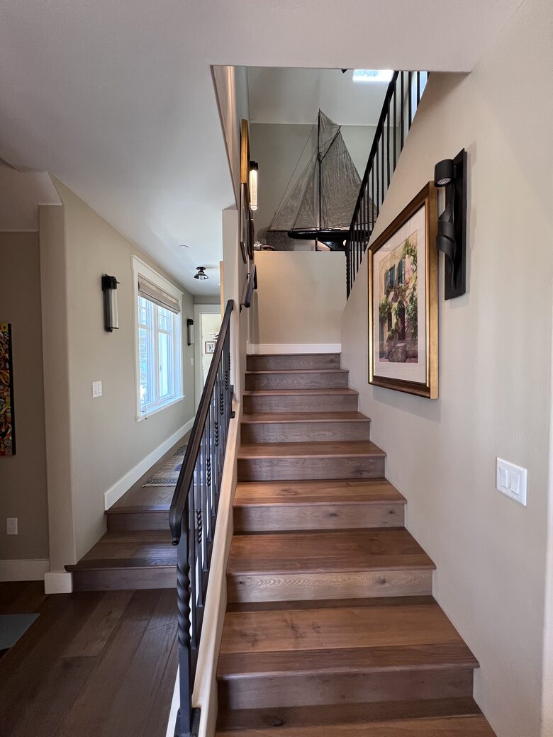 Upstairs to primary bedroom, bath, and room with balcony