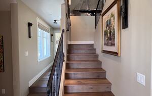 Upstairs to primary bedroom, bath, and room with balcony