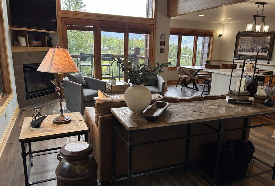 Great room with natural light and forest views