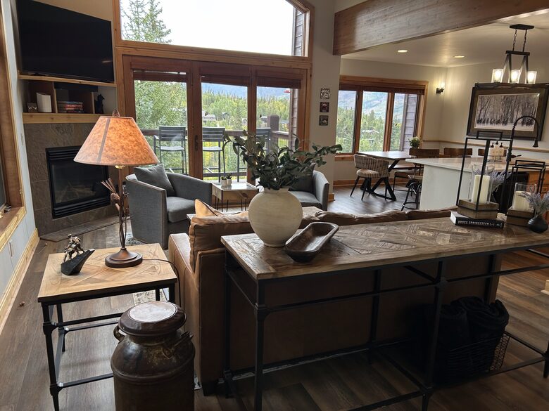 Great room with natural light and forest views