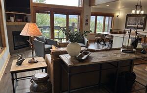 Great room with natural light and forest views