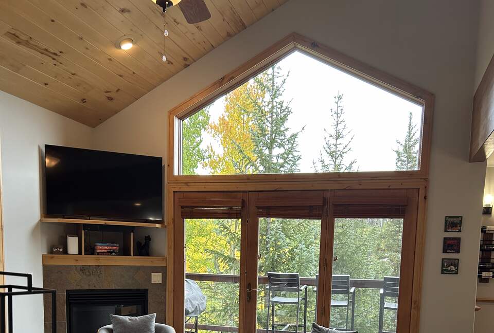 Great room with natural light and forest views