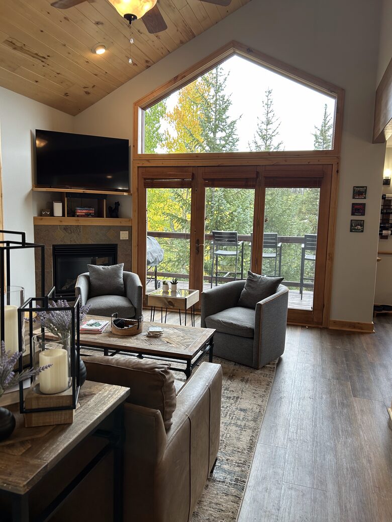 Great room with natural light and forest views