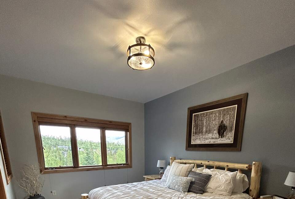 2nd bedroom with natural light and forest views