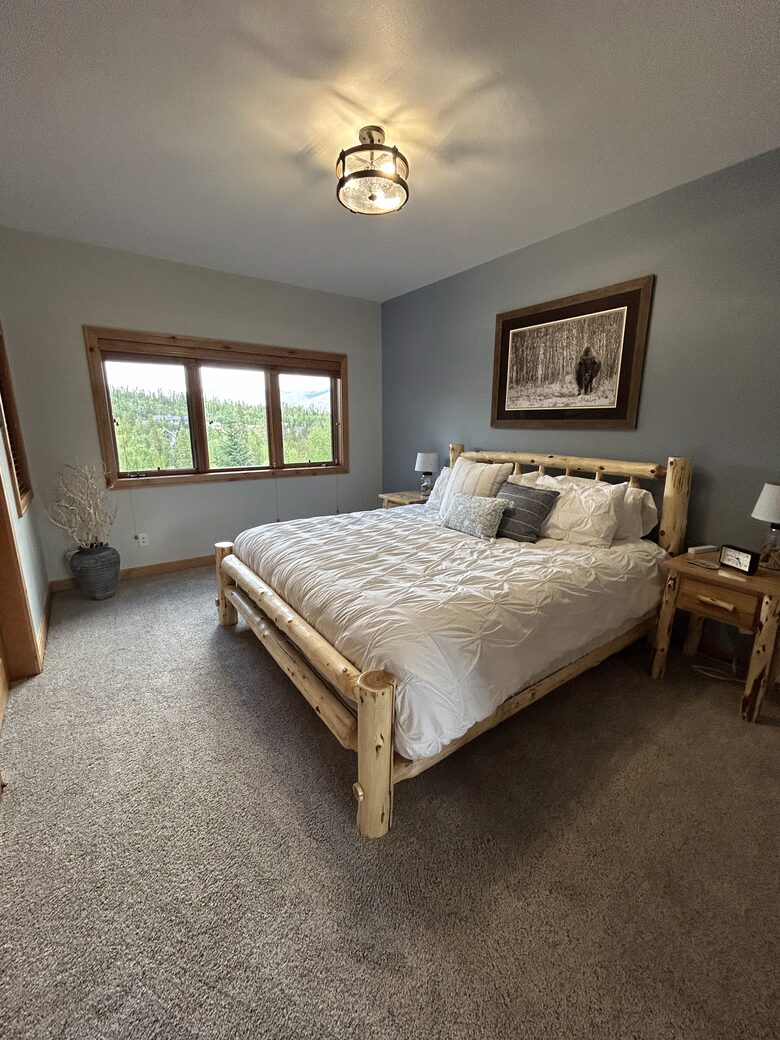 2nd bedroom with natural light and forest views