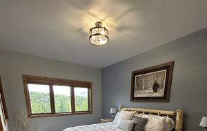 2nd bedroom with natural light and forest views