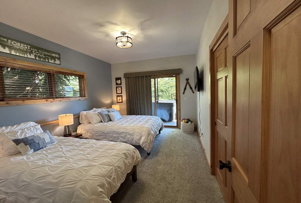 3rd bedroom with access to deck, hot tub and forest