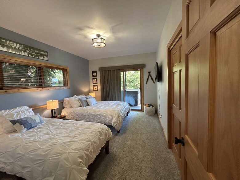 3rd bedroom with access to deck, hot tub and forest