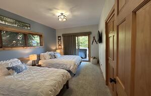3rd bedroom with access to deck, hot tub and forest
