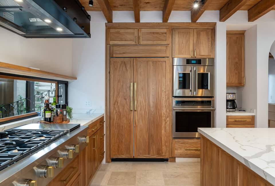 Six burner cooktop, SubZero refrigerator and double ovenss