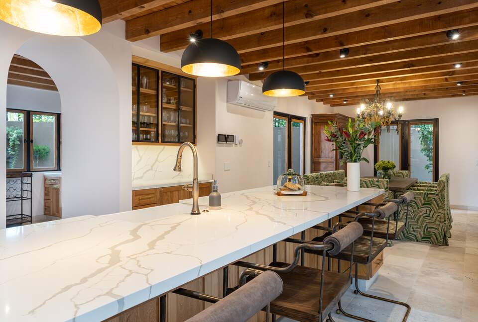 Bar area with icemaker off of kitchen