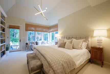 Primary bedroom with French door out to rose garden