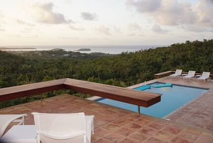 Pool and pool deck with loungers and floats. ocean views!