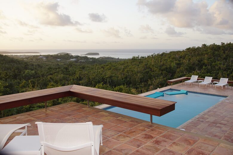 Pool and pool deck with loungers and floats. ocean views!