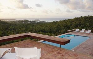 Pool and pool deck with loungers and floats. ocean views!