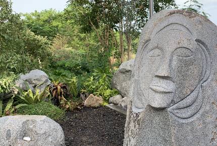 Outdoor shower with carving and surrounding jungle