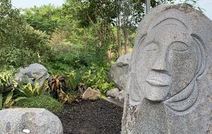 Outdoor shower with carving and surrounding jungle