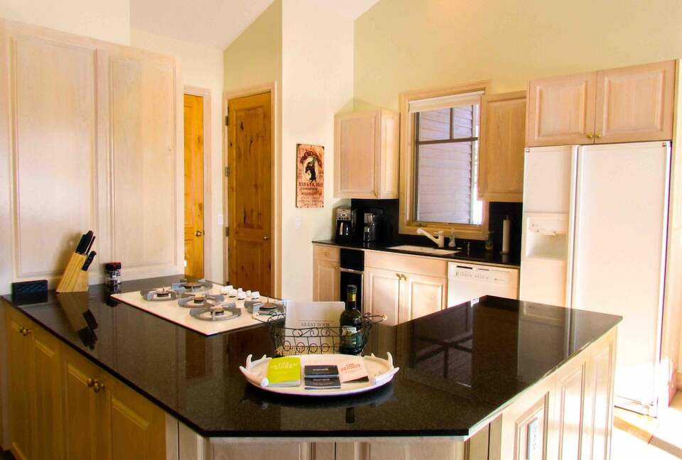 Kitchen with full appliances including coffee bean grinder and keurig