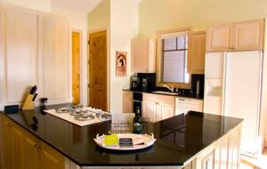 Kitchen with full appliances including coffee bean grinder and keurig