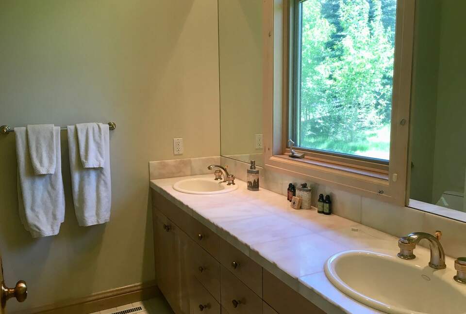 Primary bathroom with double sink and shower