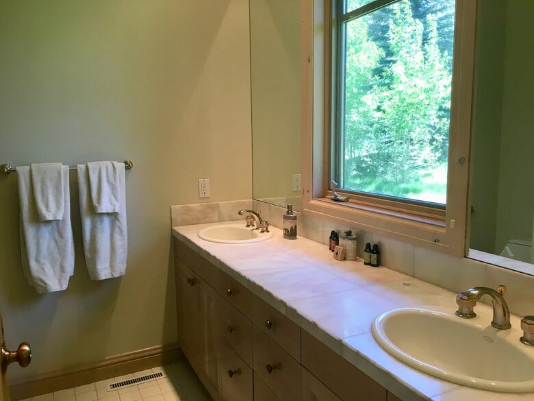 Primary bathroom with double sink and shower
