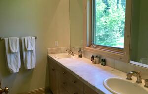 Primary bathroom with double sink and shower
